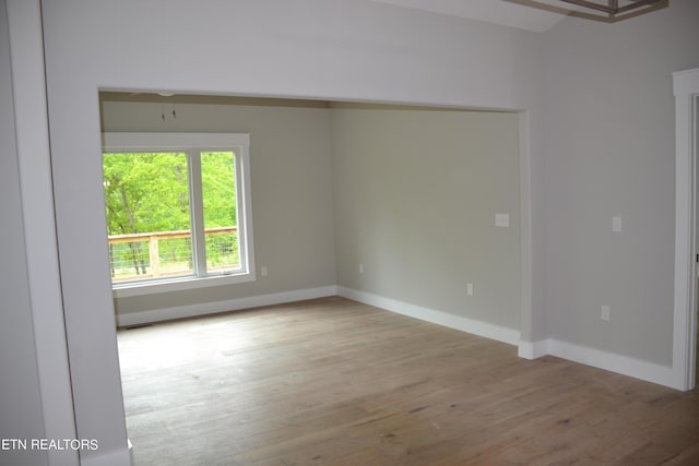 unfurnished room with light wood-type flooring