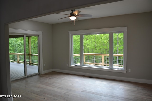 unfurnished room with ceiling fan and light wood-type flooring