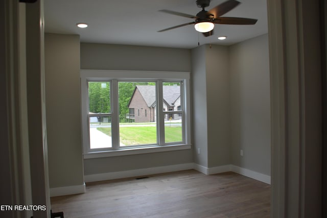 empty room featuring ceiling fan and light hardwood / wood-style floors