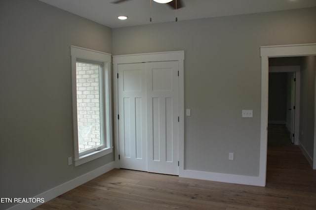 unfurnished bedroom with ceiling fan, a closet, and light wood-type flooring