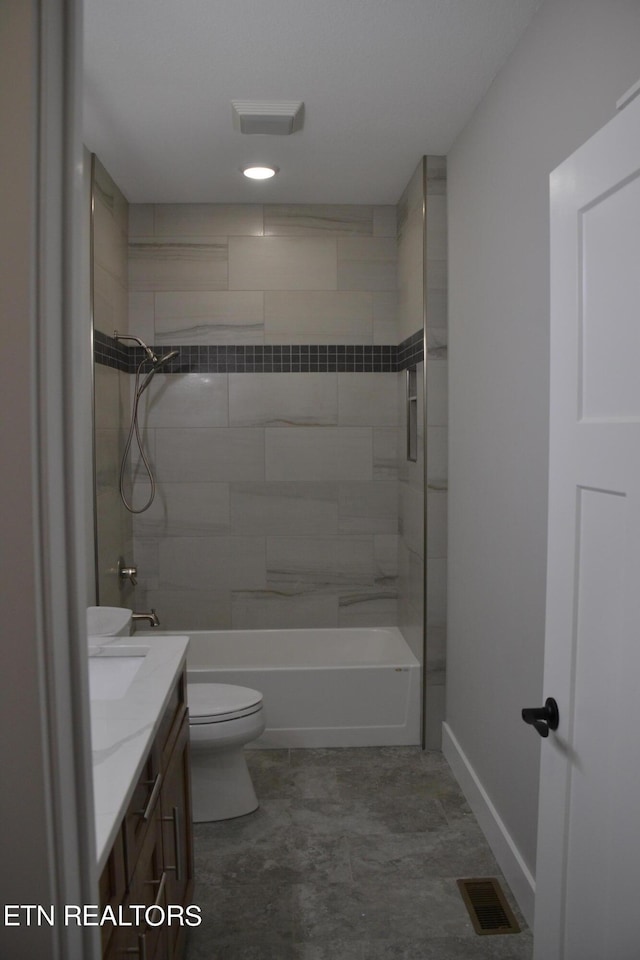 full bathroom featuring vanity, toilet, and tiled shower / bath combo