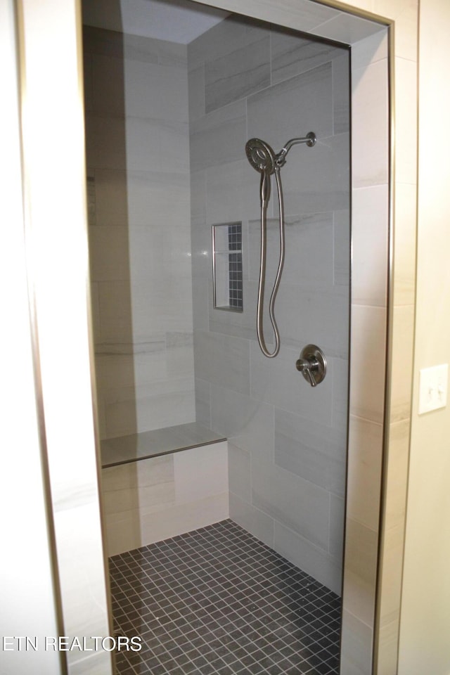 bathroom with tiled shower