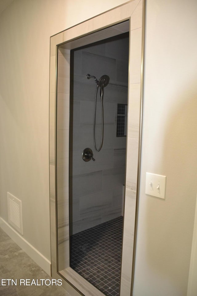 bathroom with a tile shower