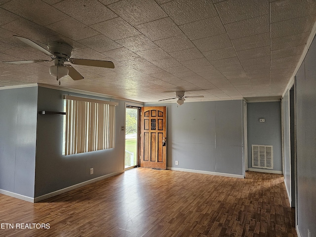 empty room with ceiling fan and hardwood / wood-style floors