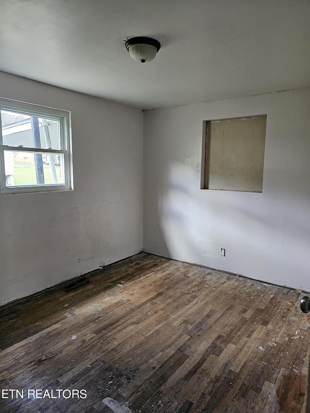 unfurnished room featuring dark hardwood / wood-style flooring