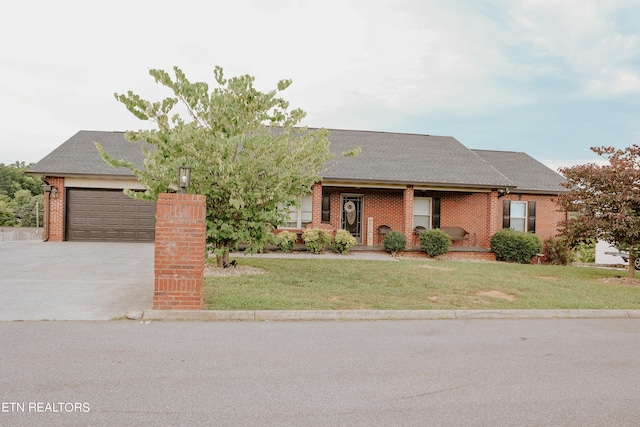 view of front of home featuring a front yard and a garage