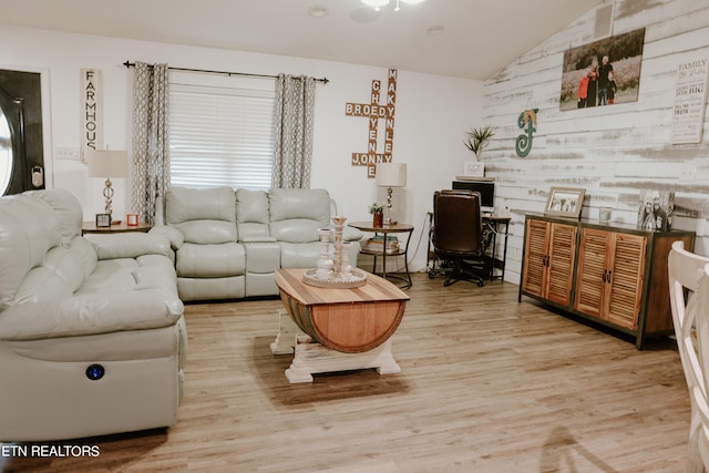 living room with vaulted ceiling and light hardwood / wood-style flooring