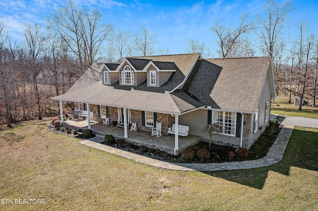 cape cod-style house with a front lawn and covered porch