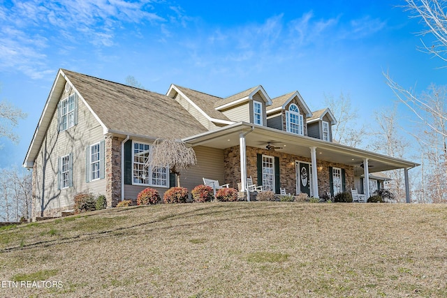 cape cod home featuring covered porch, ceiling fan, and a front lawn