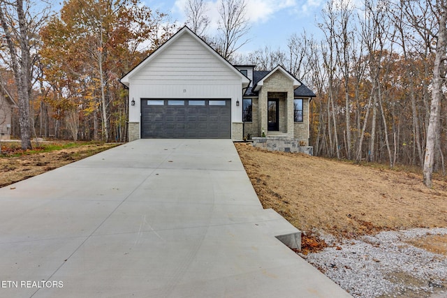 13 Norwich Ter, Fairfield Glade, TN 38558 - view of front of home featuring stone siding, driveway, and an attached garage