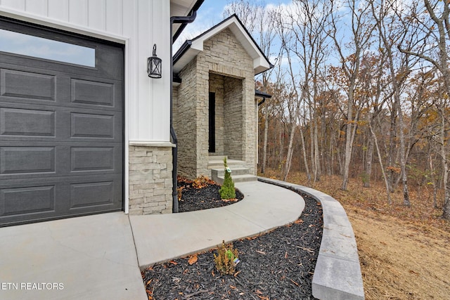 13 Norwich Ter, Fairfield Glade, TN 38558 - doorway to property featuring board and batten siding, stone siding, and a garage