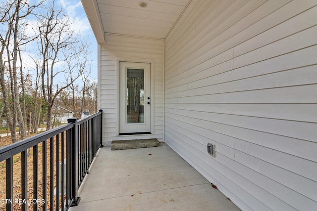 view of exterior entry featuring a balcony