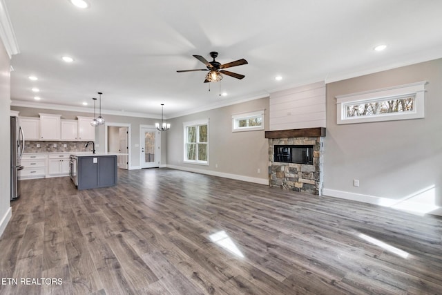 13 Norwich Ter, Fairfield Glade, TN 38558 - unfurnished living room featuring a ceiling fan, a stone fireplace, crown molding, recessed lighting, and dark wood finished floors
