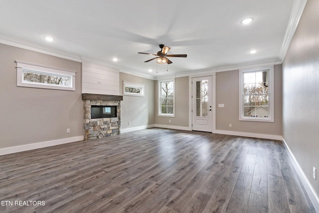 unfurnished living room with ceiling fan, dark hardwood / wood-style floors, a fireplace, and crown molding