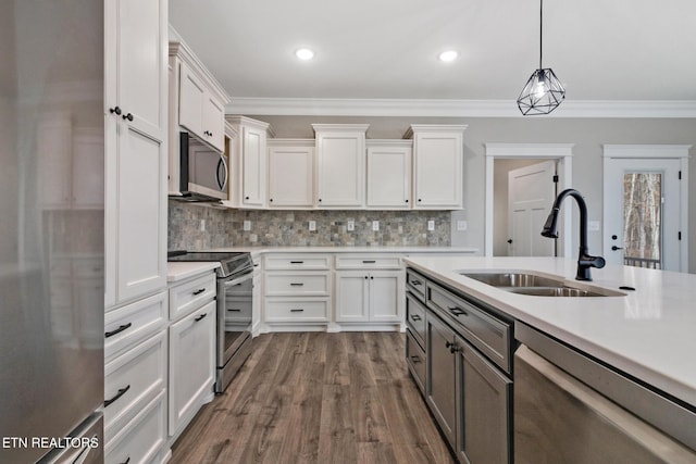 13 Norwich Ter, Fairfield Glade, TN 38558 - kitchen with appliances with stainless steel finishes, light countertops, white cabinetry, ornamental molding, and decorative light fixtures