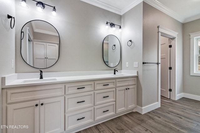 bathroom featuring vanity, hardwood / wood-style flooring, and crown molding