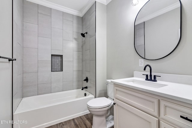 full bathroom with ornamental molding, hardwood / wood-style floors, vanity, toilet, and tiled shower / bath combo