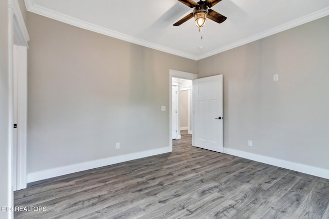 empty room with wood-type flooring, ceiling fan, and crown molding