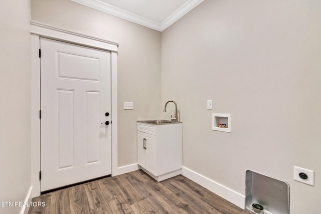 clothes washing area featuring cabinets, dark hardwood / wood-style floors, electric dryer hookup, and crown molding