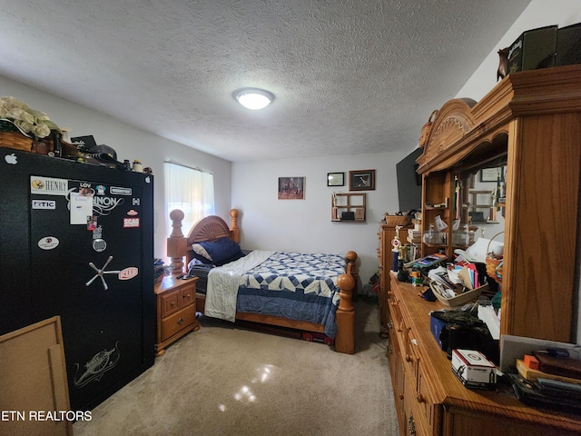 carpeted bedroom featuring a textured ceiling and black refrigerator