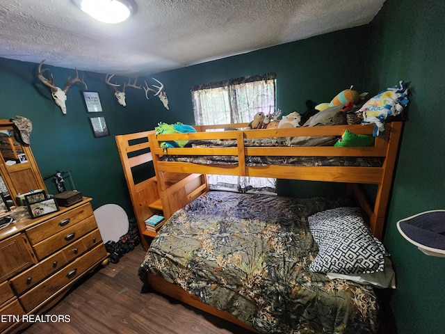 bedroom featuring dark hardwood / wood-style floors and a textured ceiling