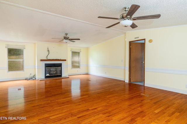 unfurnished living room featuring wood-type flooring, a textured ceiling, and ceiling fan