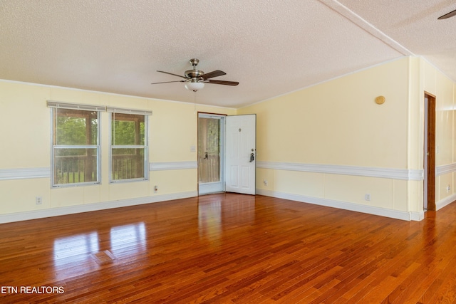 empty room with a textured ceiling, hardwood / wood-style flooring, and ceiling fan