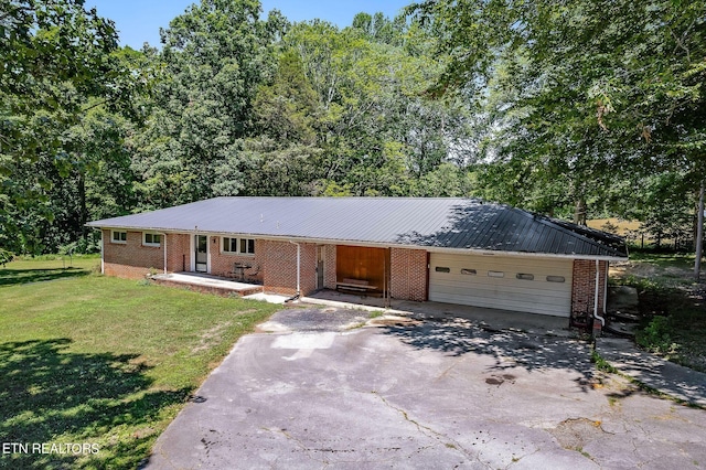 ranch-style home featuring a garage and a front yard