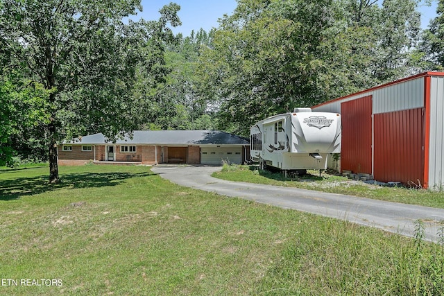 view of front of property with a front lawn and a garage