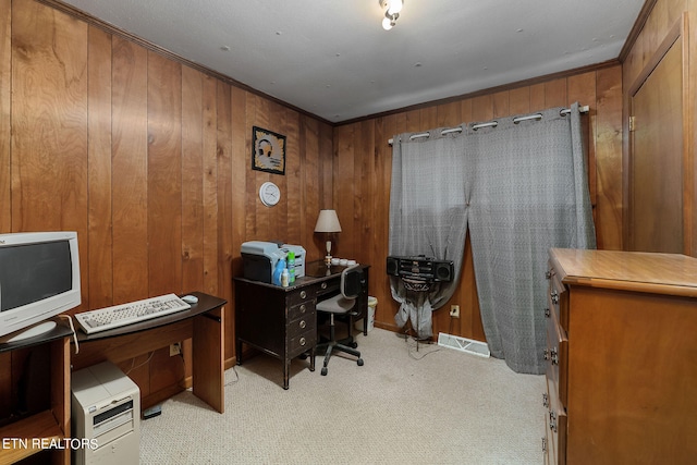 office featuring light carpet, ornamental molding, and wooden walls