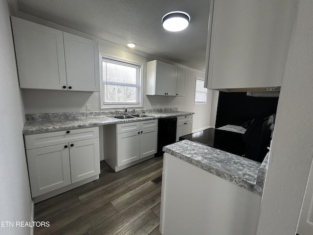 kitchen with sink, dark hardwood / wood-style floors, a textured ceiling, white cabinets, and black appliances