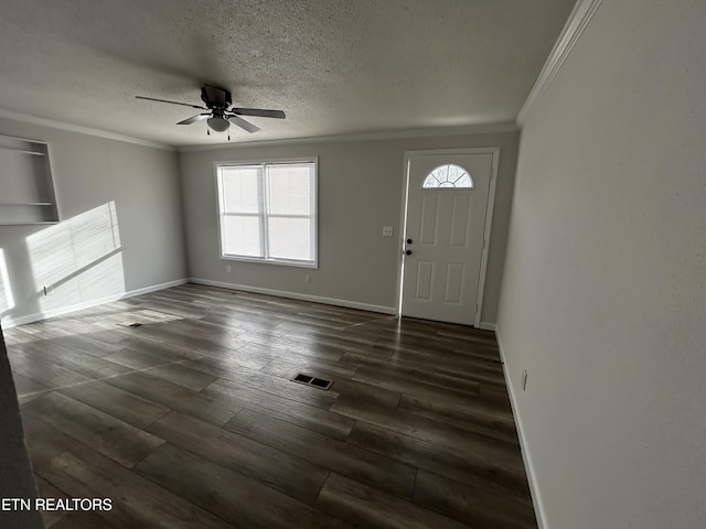 entrance foyer with ceiling fan, dark hardwood / wood-style flooring, a textured ceiling, and ornamental molding