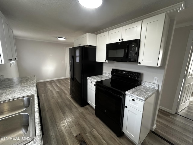 kitchen featuring black appliances, dark hardwood / wood-style floors, white cabinetry, and sink