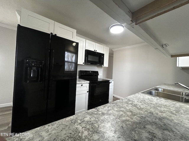 kitchen featuring beam ceiling, white cabinetry, sink, hardwood / wood-style floors, and black appliances