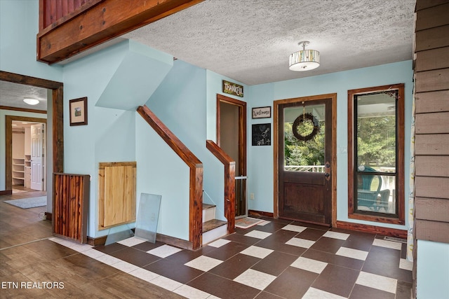 foyer with a textured ceiling