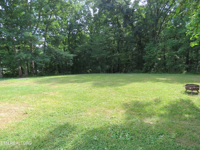 view of yard with a fire pit