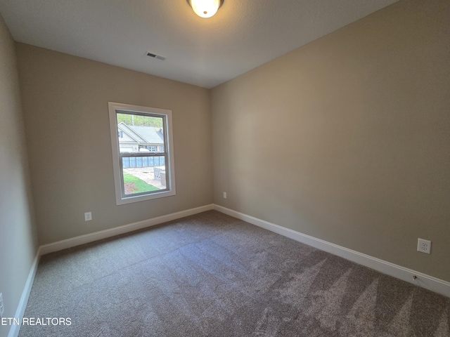 unfurnished room featuring visible vents, carpet flooring, and baseboards