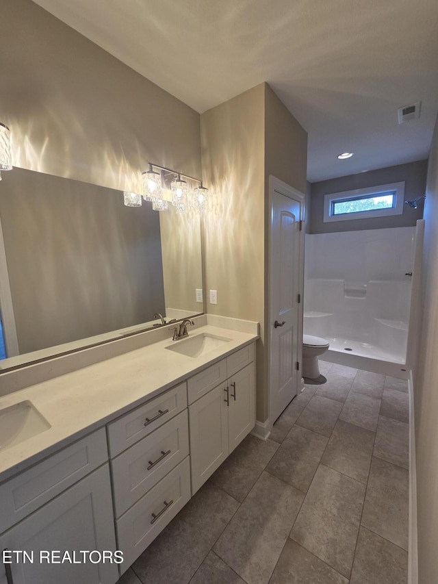 bathroom with walk in shower, visible vents, toilet, and a sink