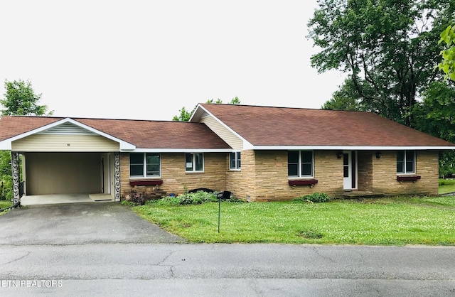 single story home with a front yard and a carport