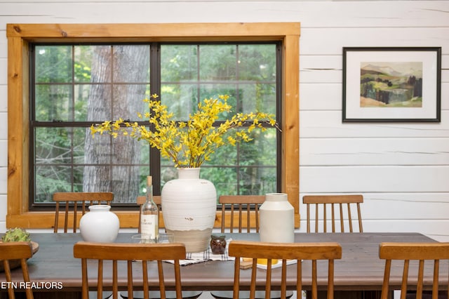 dining room featuring wood walls