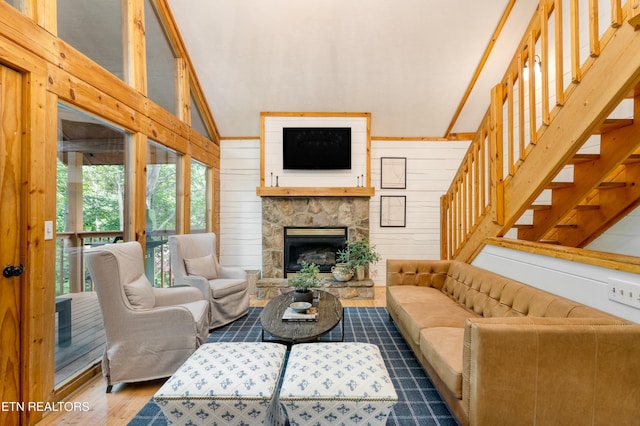 living room featuring a fireplace, dark hardwood / wood-style floors, high vaulted ceiling, and wooden walls