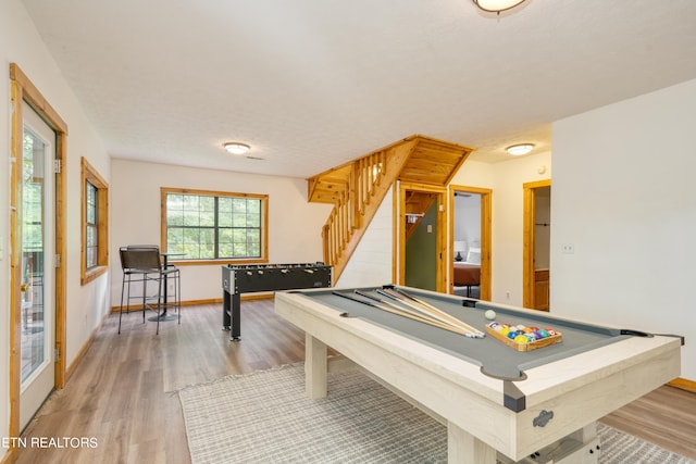 recreation room with a textured ceiling, hardwood / wood-style flooring, and pool table