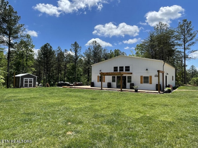 back of house with a lawn, a patio area, and a shed