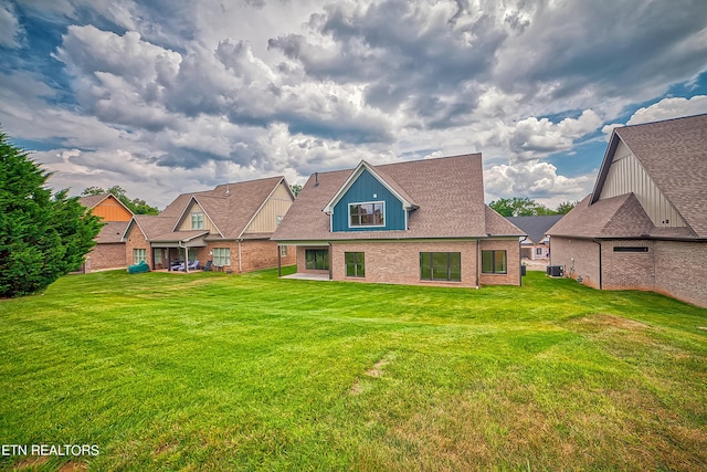 rear view of property featuring a yard