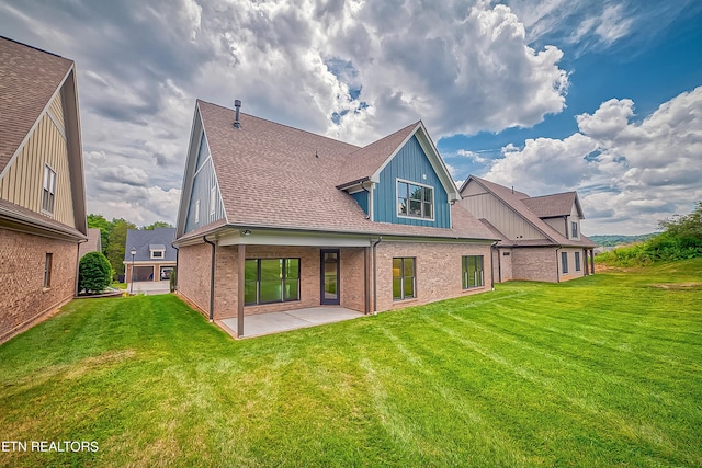 rear view of property featuring a patio area and a yard