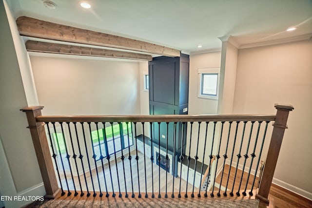 corridor featuring hardwood / wood-style floors and crown molding