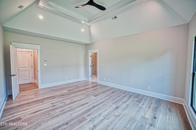 unfurnished bedroom featuring ceiling fan, lofted ceiling, and light wood-type flooring