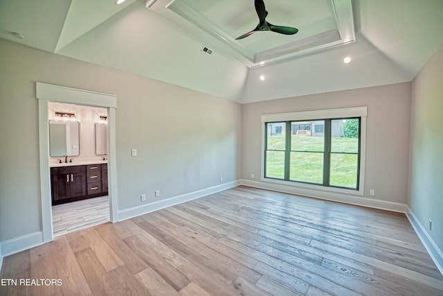 unfurnished bedroom featuring ensuite bath, ceiling fan, sink, and light hardwood / wood-style floors