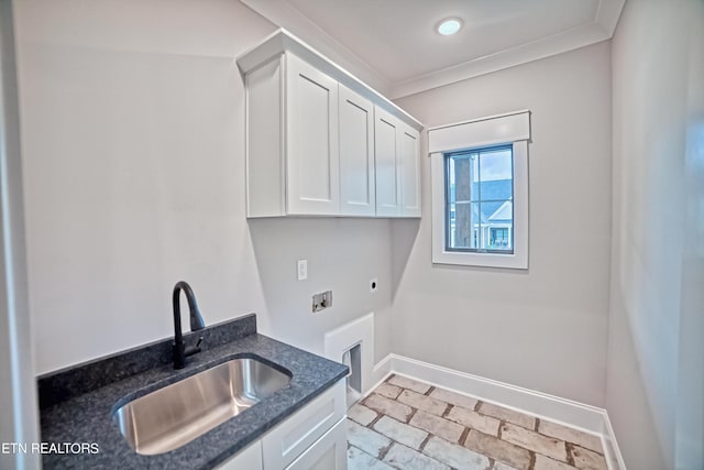 clothes washing area with cabinets, crown molding, sink, hookup for a washing machine, and hookup for an electric dryer