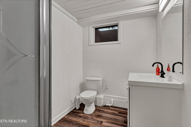 bathroom with wood-type flooring, vanity, toilet, and crown molding